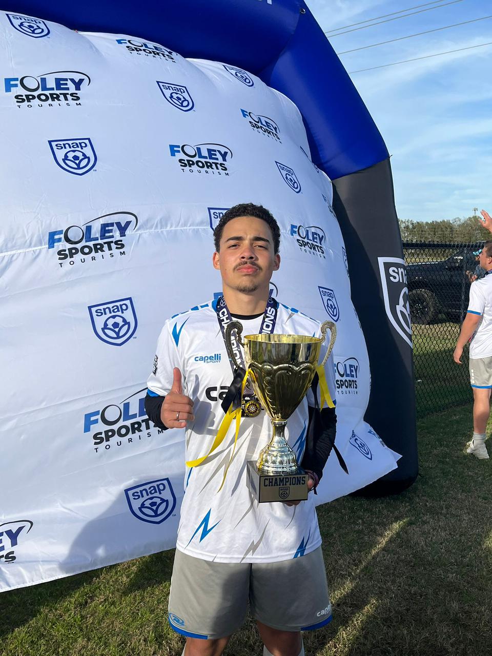 Kaynan Lucca with Foley Cup trophy